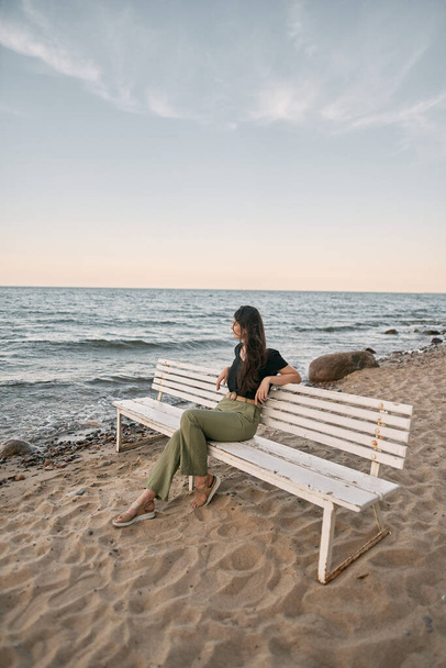 Lonely woman on the beach. COncept photo of depressed emotion and loneliness - Zdjęcie, obraz