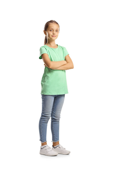 Full length portrait of a girl in a green t-shirt and jeans isolated on white background - 写真・画像
