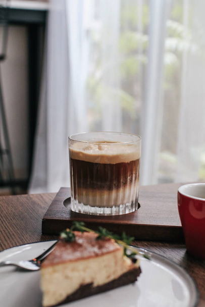 Latte macchiato layered coffee on wooden table. Fresh morning coffee. Cappuccino, americano, espresso. - Fotoğraf, Görsel