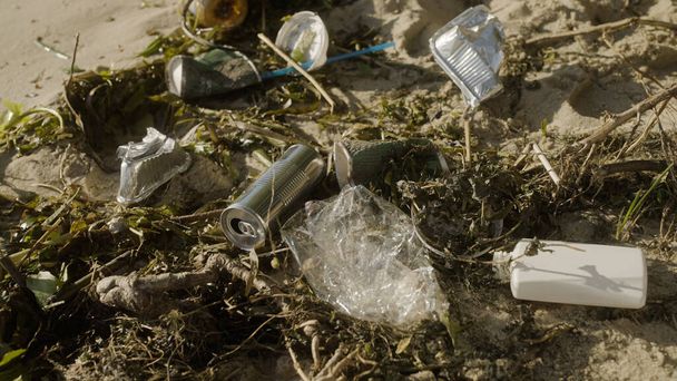Piles of unsorted garbage on beach, environmental pollution, damage to nature - 写真・画像