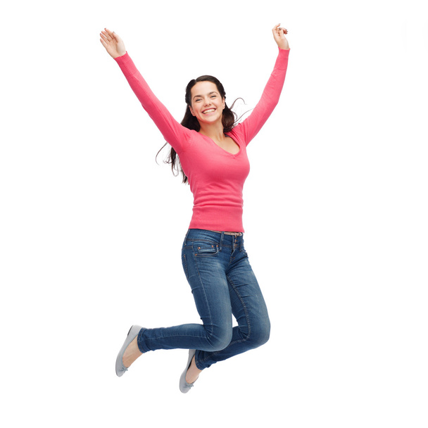 smiling young woman jumping in air - Φωτογραφία, εικόνα