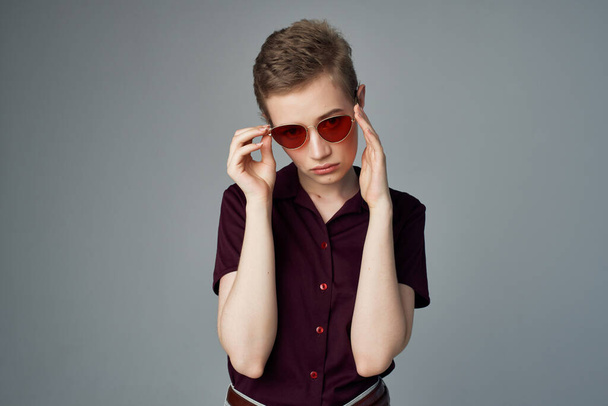 short haired woman with sunglasses fashion light background - 写真・画像
