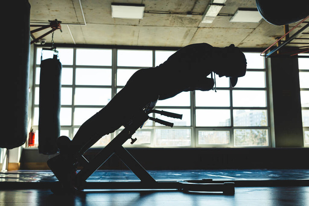 The athlete is training in the gym opposite the window. Abdominal Exercise - Valokuva, kuva