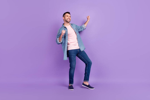 Full length body size photo man smiling dancing at party dreamy looking copyspace isolated pastel violet color background - Foto, immagini