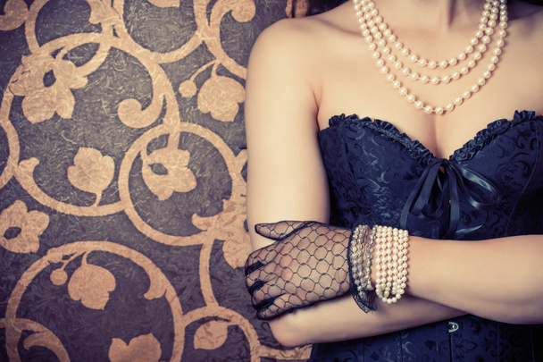 Woman wearing black corset and pearls - Fotó, kép