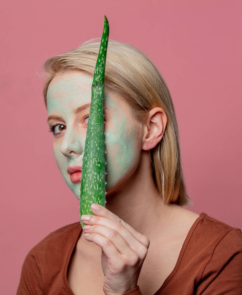 beautiful blond girl with green mask and aloe branch - Foto, immagini