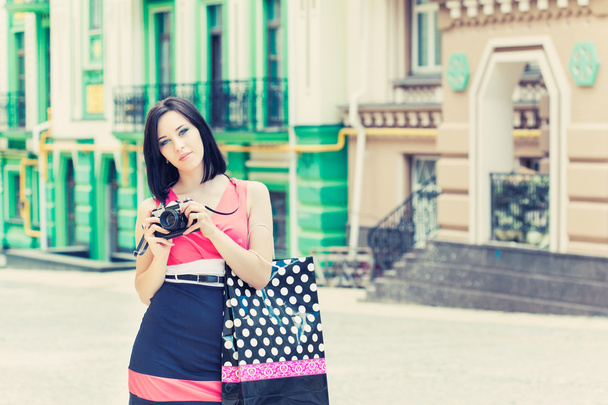 Woman taking photos with vintage camera - Foto, imagen