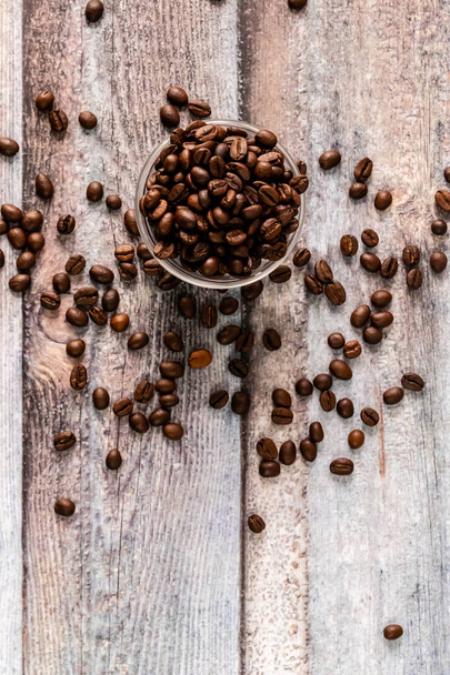 Top shot of coffee beans in glass bowl with portrait orientation and copy space - Fotografie, Obrázek