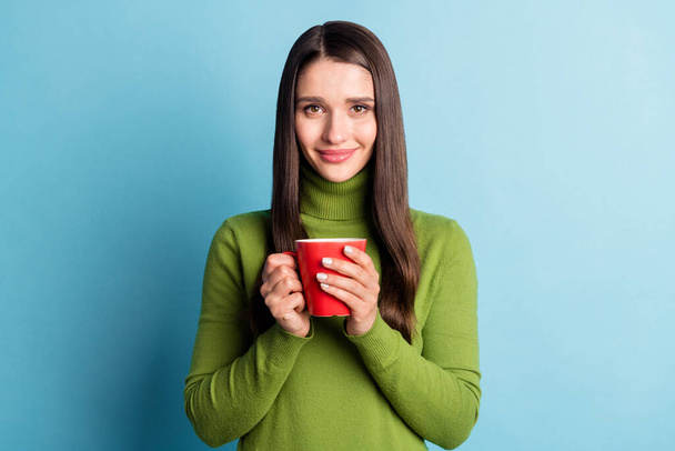 Photo of charming pretty nice lady hold cup drink cacao wear green turtleneck isolated on blue background - Φωτογραφία, εικόνα