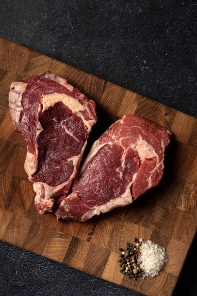 Raw marbled beef steak on a wooden cutting board - Fotografie, Obrázek