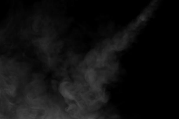 Close-up view of white water vapor with spray from the humidifier. Isolated on black background - Photo, Image