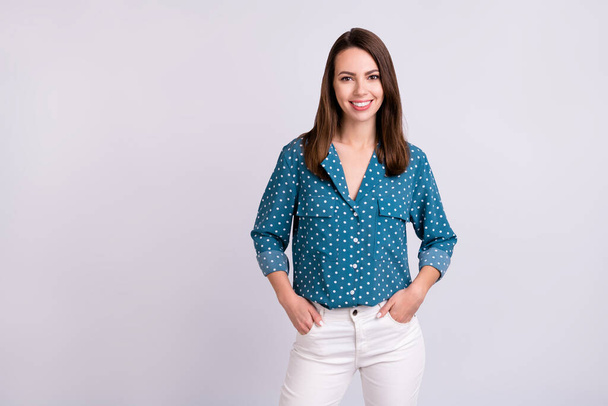 Photo of nice brunette hair millennial lady stand wear blue shirt white jeans isolated on grey color background - Fotoğraf, Görsel