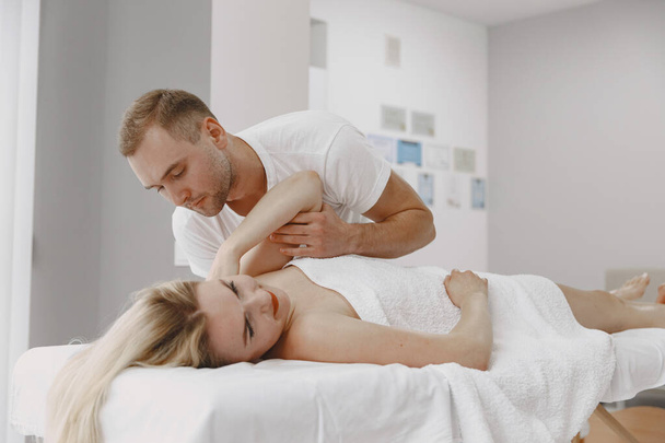 Male physiotherapist massaging womans back - Valokuva, kuva