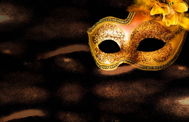 Złota maska karnawałowa na ciemnym tle. Koncepcja Mardi Gras. Kreatywna przestrzeń do kopiowania - Zdjęcie, obraz