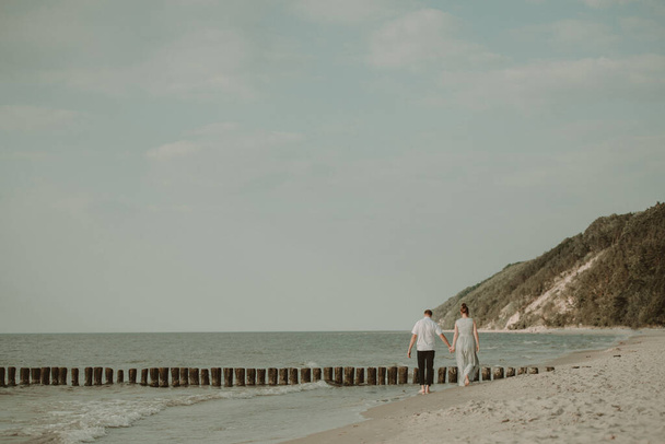 Bride and groom at a photo session in the nature. Baltic sea beach. - Photo, Image