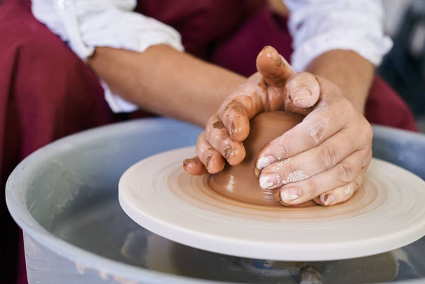 closeup female hands twist clay on potter's wheel - Photo, Image