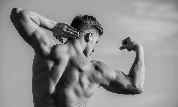Bigger muscles grow. Increase overall muscle mass. Man muscular chest naked torso sky background. Man muscular athlete bodybuilder show muscles. Bodybuilder shape. Sexy body. Triumph and loss - Foto, imagen