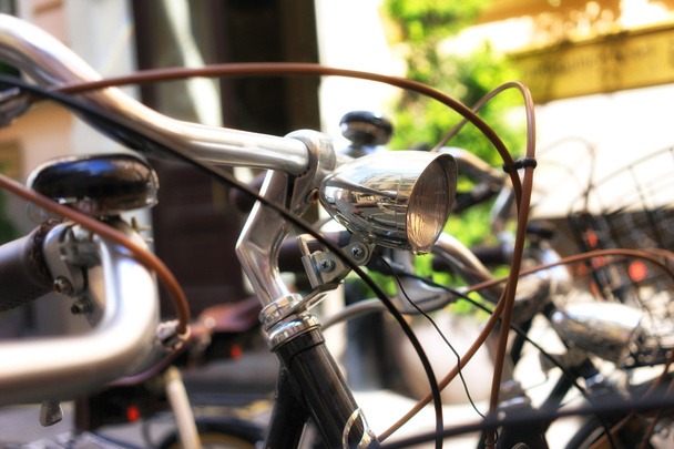 Bicycles with a headlamp are in the parking lot near the house - Photo, Image