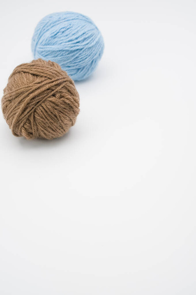 A vertical shot of isolated colorful yarns on a white background with text space - Fotografie, Obrázek