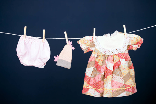 Baby clothes hanging on the clothesline. - Foto, imagen