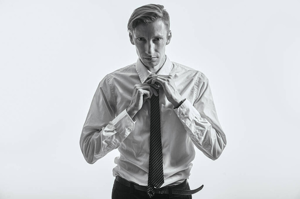 Tired manager tying tie is sad and depressed - Foto, afbeelding