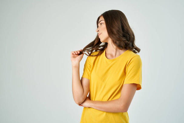 woman in yellow t-shirt gestures with hand Copy Space emotions lifestyle - Photo, image