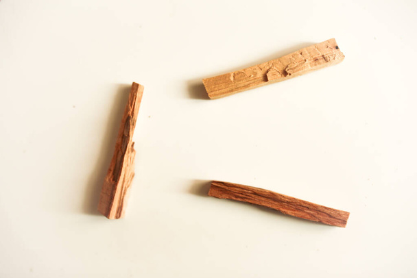 A top view image of several sticks of palo santo wood on a white background. - Photo, image