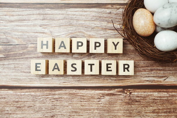 Happy Easter Holidays background with Easter Eggs decoration on wooden background - Foto, Imagen