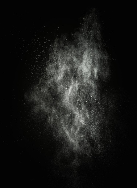 White powder exploding isolated on black - Foto, Bild