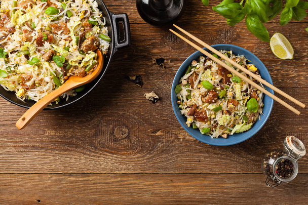 Fried veal, with rice, Chinese cabbage and mushrooms. Sprinkled with sesame and soy sauce. Top view.  - Fotografie, Obrázek