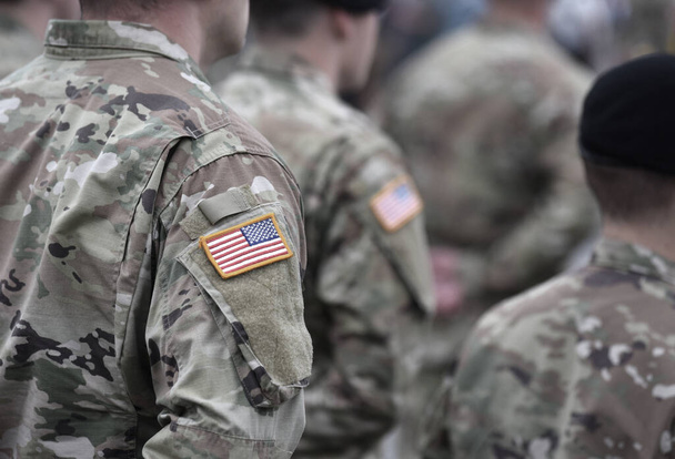 US soldiers. US army. USA patch flag on the US military uniform. Soldiers on the parade ground from the back. Veterans Day. Memorial Day. - Photo, image