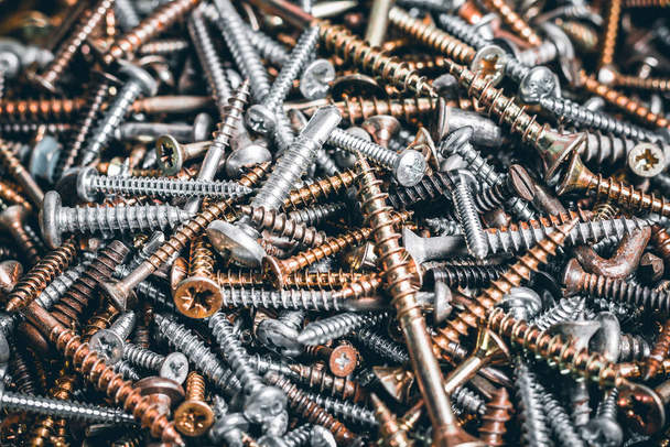 Close up look on a lot of screws. Macro of different kind of Screws. Set of screws. Construction abstraction. Industrial background. Tapping screws made of steel, iron, chrome. - Fotografie, Obrázek