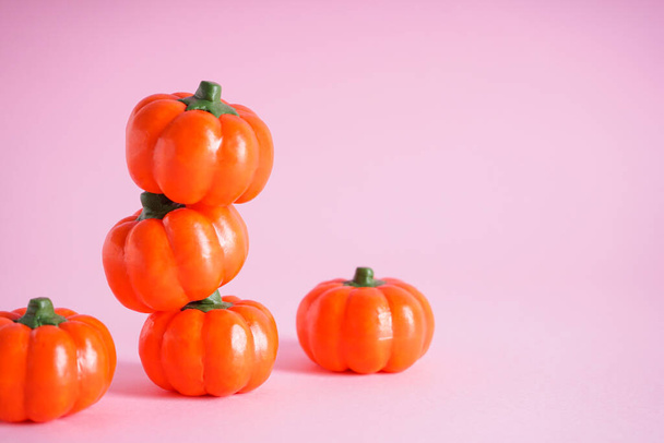Halloween concept. Halloween pumpkins on a pink background, space for text.  - Foto, Imagem