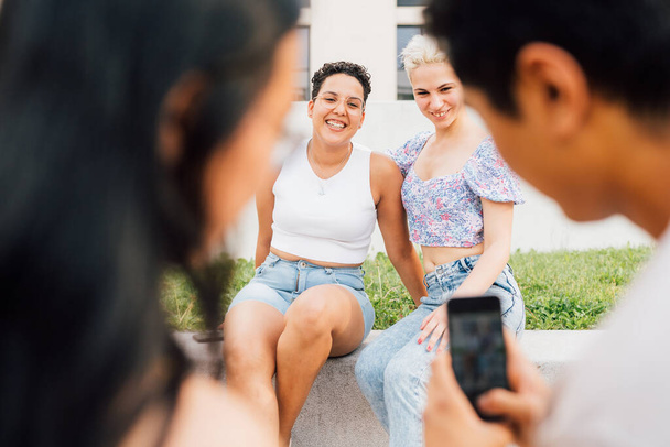 若い多民族グループの友人屋外で一緒にスマートフォンで写真を撮る楽しみを持つ観光客 - 写真・画像