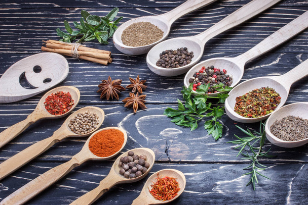 Colorful aromatic Indian spices and herbs on an old oak wooden brown backgrownd - Photo, Image