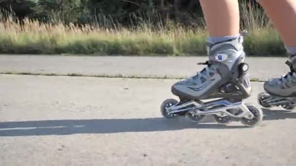 Gray roller skates on the female legs of sportive girl close up on abandoned airport. - Footage, Video