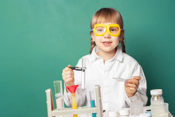 Kid tiedemies tekee kokeita kotona tai koulussa laboratoriossa. Lapsen ja tieteen opetuksen käsite - Valokuva, kuva