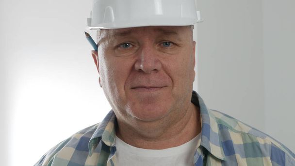 Portrait with an Engineer Wearing Helmet and Smiling Happy. - Zdjęcie, obraz