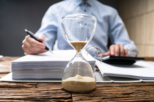 Hourglass At Desk. Legal Deadline. Late Business Invoice - Foto, Imagen