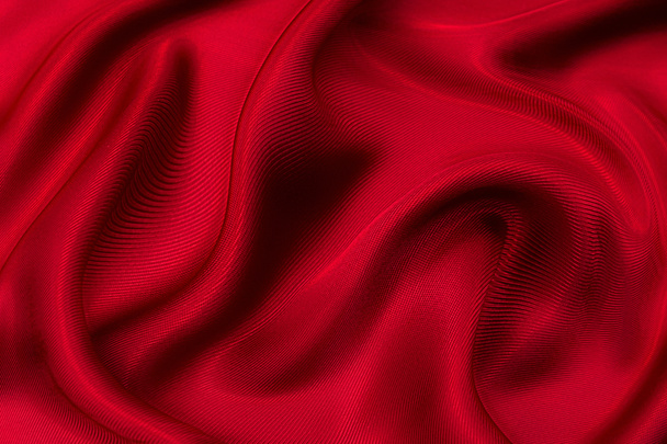 Close-up texture of natural red or pink fabric or cloth in same color. Fabric texture of natural cotton, silk or wool, or linen textile material. Red and orange canvas background - Photo, Image