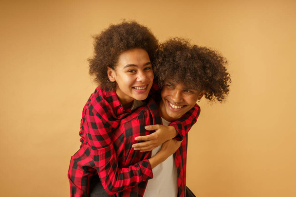 Happy and carefree afro boyfriend and girlfriend play together - Photo, Image