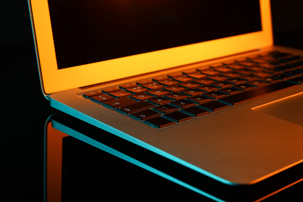Modern laptop on dark background, closeup - Photo, Image
