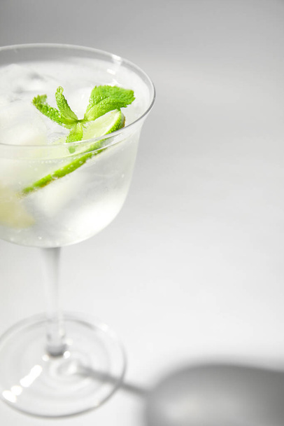 Glass of cold gin and tonic on white background - Foto, Imagem