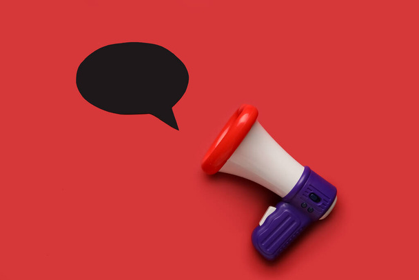 Toy megaphone and speech bubble on color background - Photo, Image