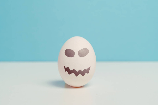 An egg with evil smile. Halloween holiday - Photo, Image