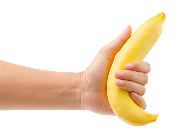 Hand holding ripe banana fruit isolated on white background, Save clipping path. - Foto, imagen