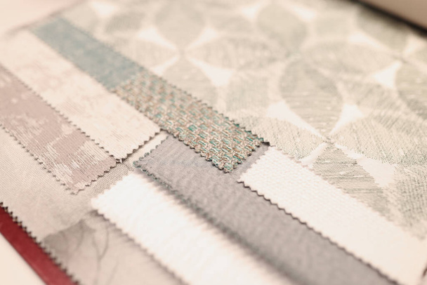 Closeup of samples of upholstery fabrics in store. Interior design assistance in choosing fabric concept - Photo, Image