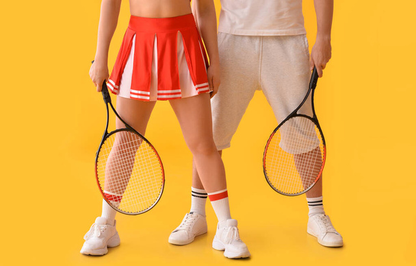 Cheerleader and tennis player on color background - Photo, Image
