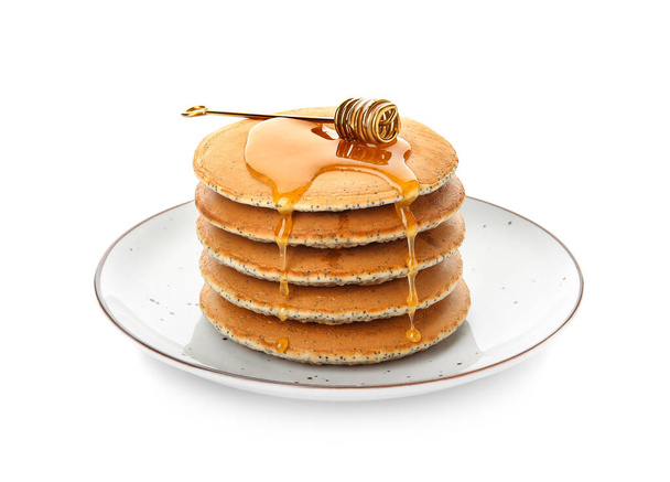 Plaat van smakelijke pannenkoeken met honing op witte achtergrond - Foto, afbeelding