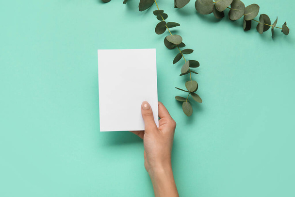 Female hand with blank card on color background - Photo, Image